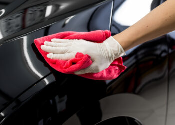 Closeup of hand cleaning black car